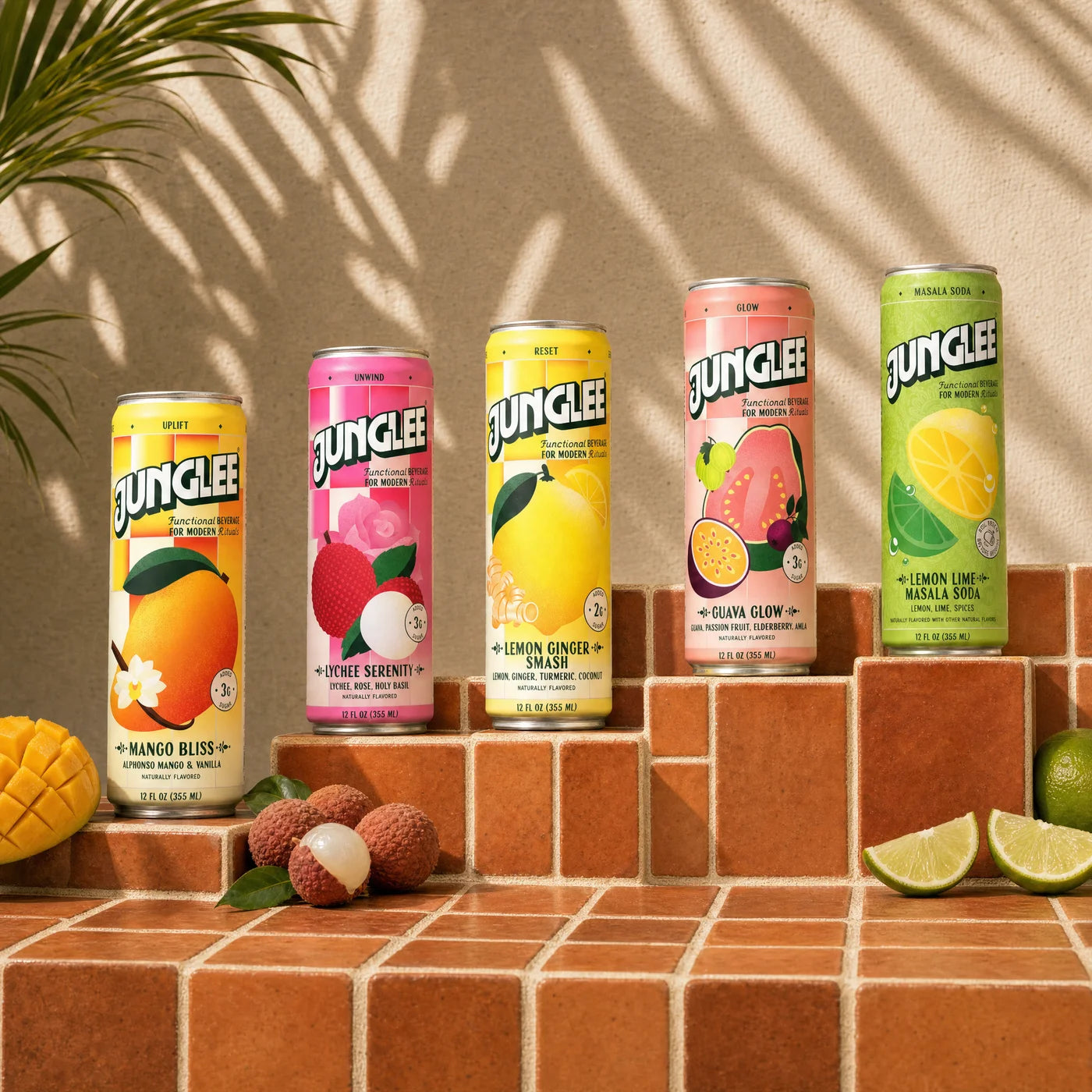 All five Junglee 12 oz flavors on terracotta tile steps with fresh fruit