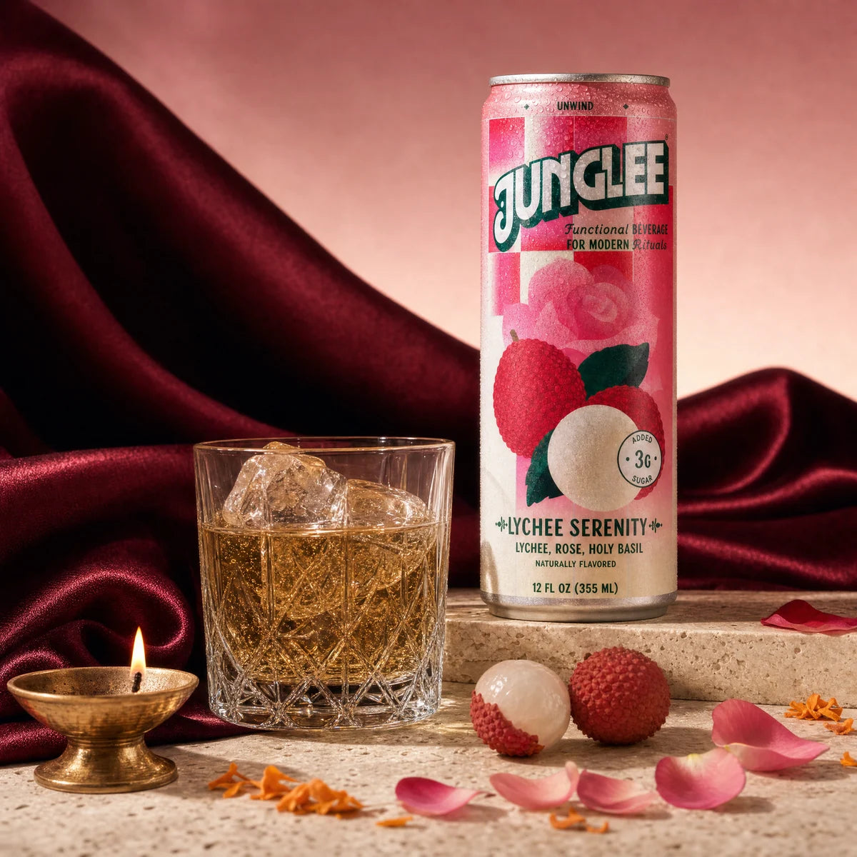 Lychee Serenity with a golden-brown drink, burgundy silk, rose petals and a brass diya