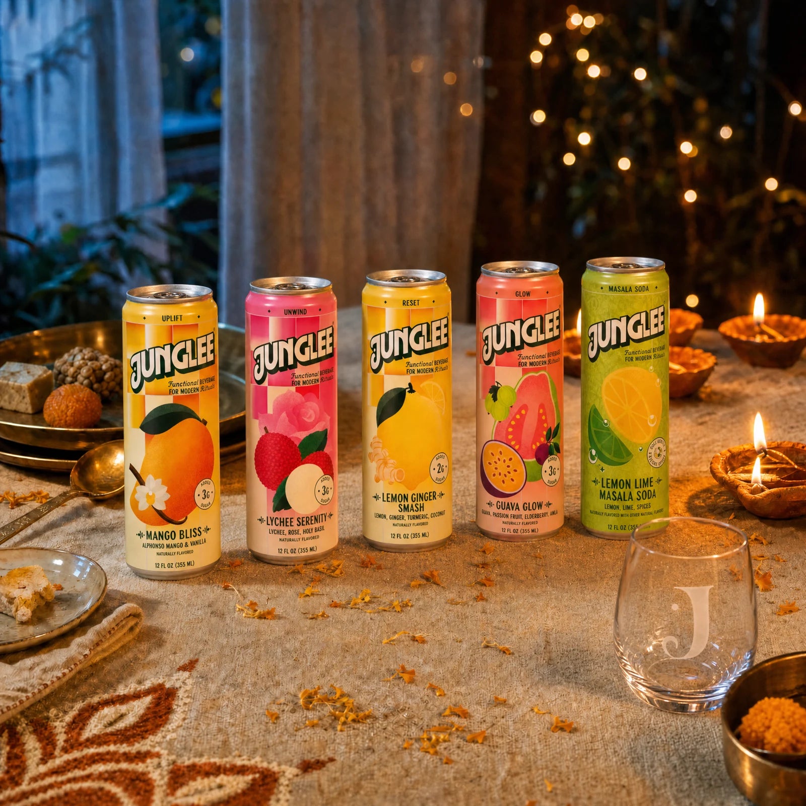 Junglee cans and the engraved glass on a Diwali table with glowing diyas, marigolds and festive sweets