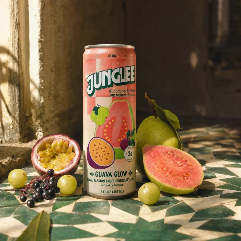 Guava Glow 12 oz can with pink guava, passion fruit & elderberry on sunlit green tiles