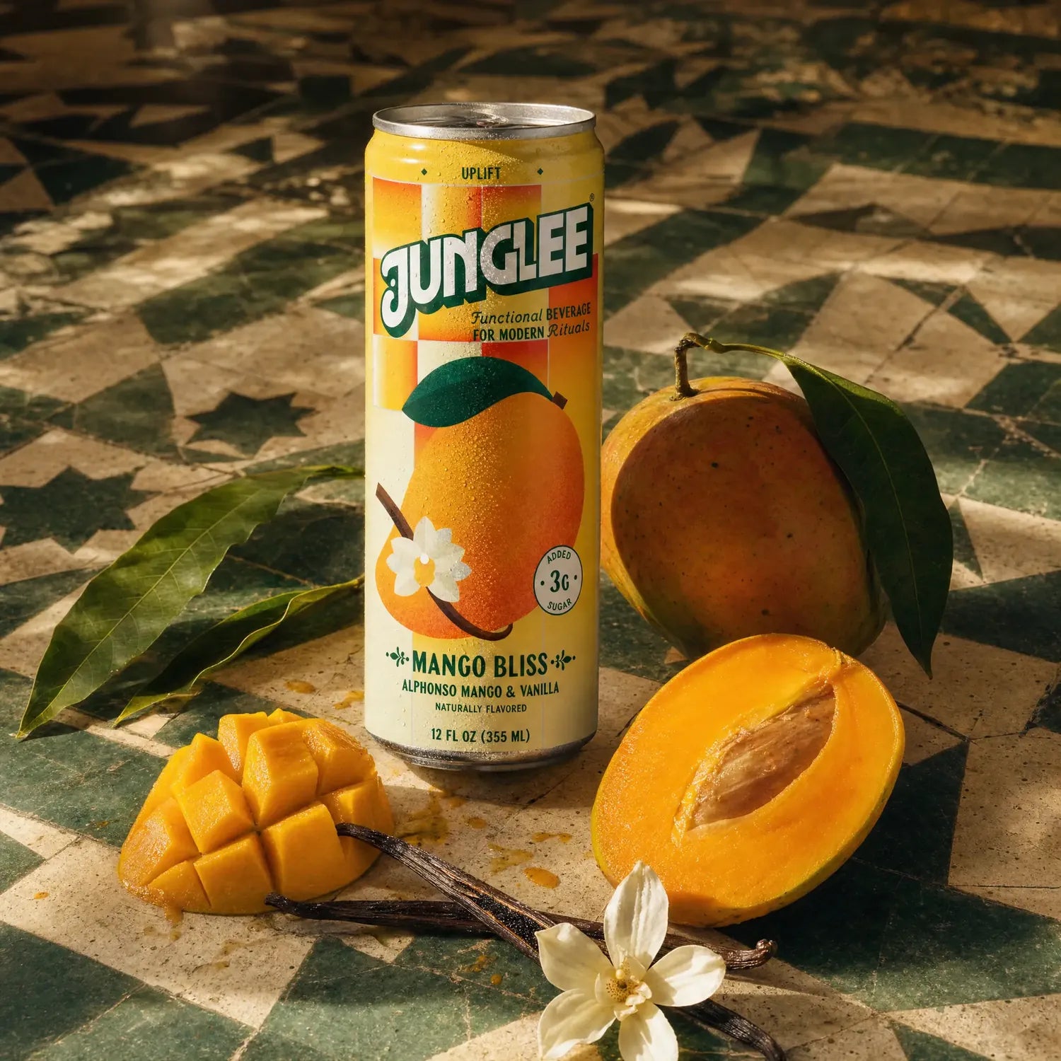 Mango Bliss 12 oz can with fresh Alphonso mango, vanilla and leaves on green and cream tiles