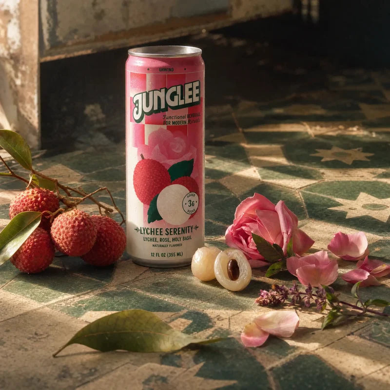 Lychee Serenity 12 oz can with lychee, rose & holy basil on sunlit green tiles